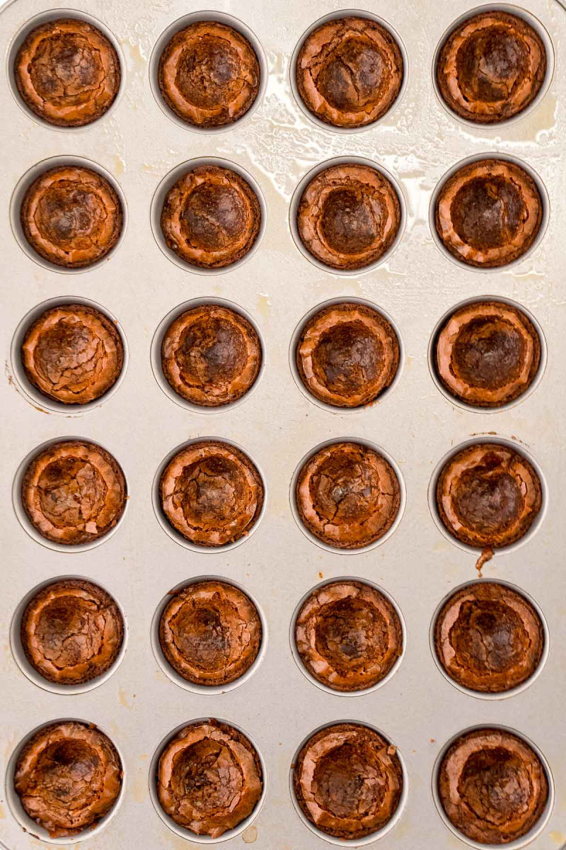mini browkies in the pan tapped down to make brownie cups
