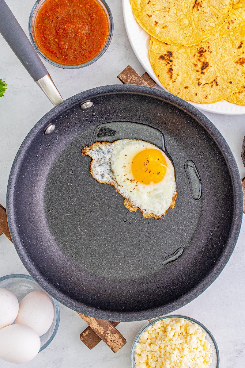 fried egg in a non stick skillet with a little oil