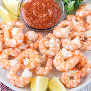 square image of shrimp cocktail next to a bowl of cocktail sauce