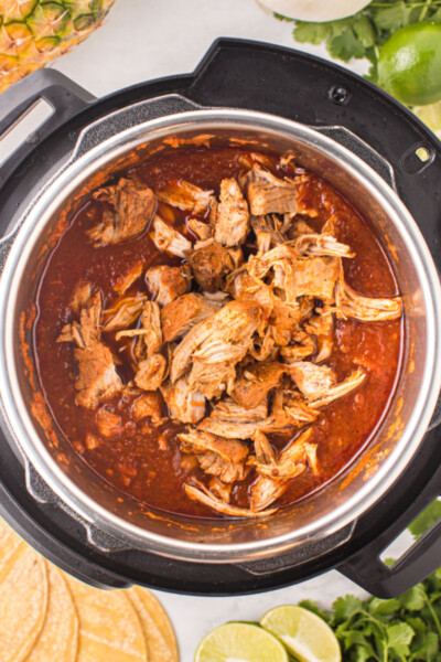 cooked, shredded pork added back to the instant pot of al pastor sauce