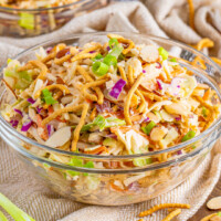 square image of creamy asian slaw in a glass serving bowl