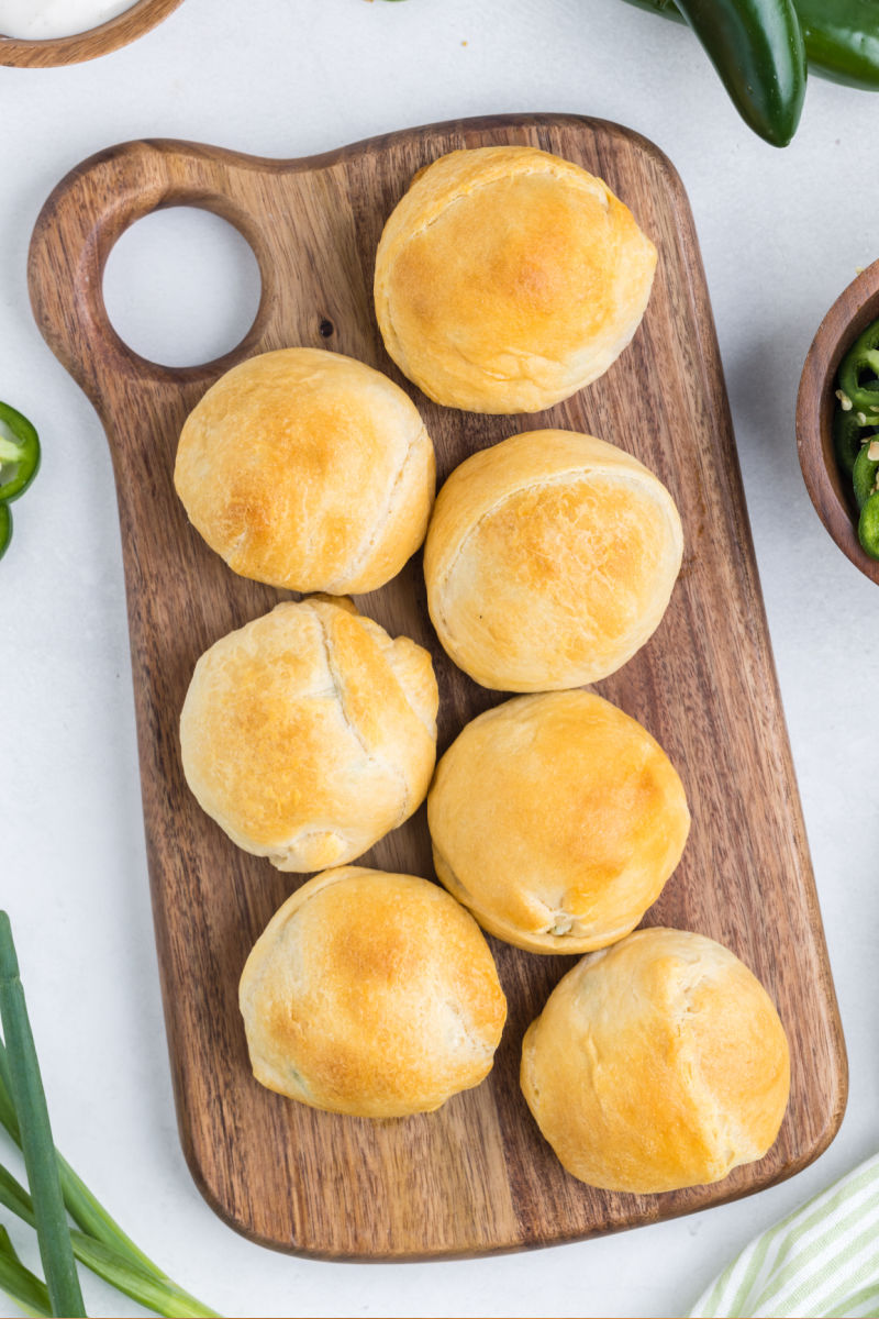 looking down at whole jalapeno popper bites on a wooden tray