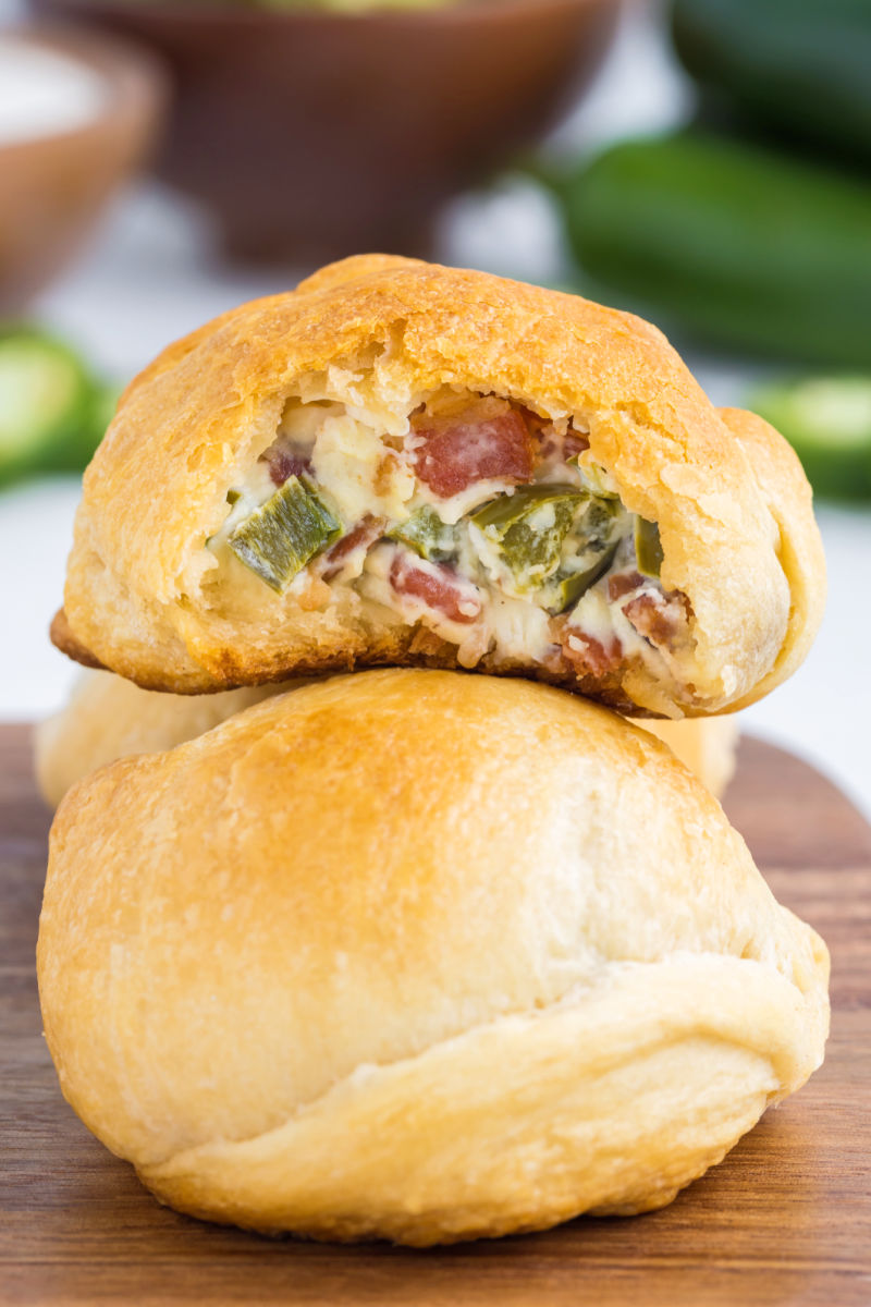 jalapeno popper bite with a bite taken out resting on top of another one