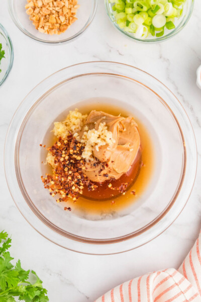 thai peanut sauce ingredients in a glass mixing bowl