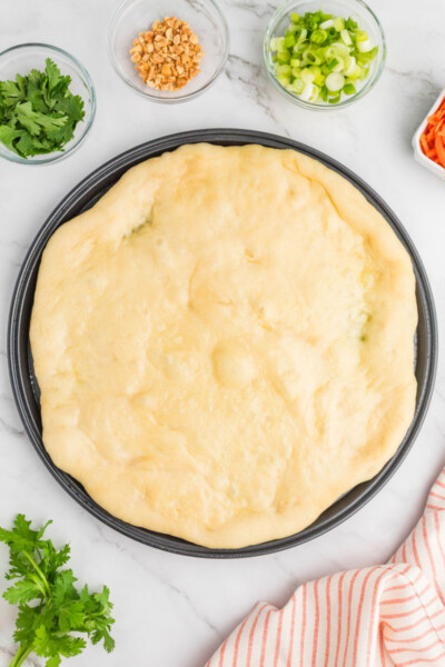 par-baked pizza crust on a round pizza pan