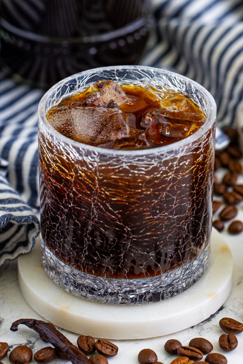 angled view of a rocks glass of coffee liqueur over ice